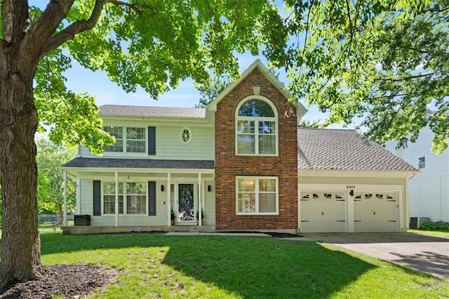 8443 Mettee St, Lenexa, KS 66219 - traditional home with a garage, concrete driveway, and a front yard