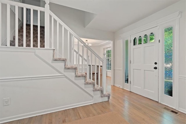 8443 Mettee St, Lenexa, KS 66219 - foyer entrance featuring stairs and wood finished floors