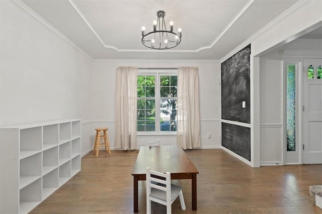 8443 Mettee St, Lenexa, KS 66219 - dining area with a raised ceiling, a chandelier, and wood finished floors