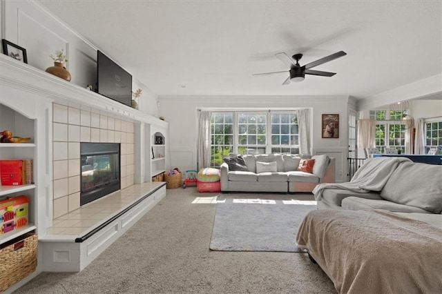 8443 Mettee St, Lenexa, KS 66219 - living room featuring carpet floors, ceiling fan, a fireplace, and crown molding