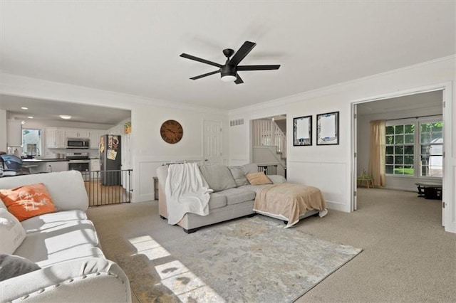 8443 Mettee St, Lenexa, KS 66219 - living room featuring light carpet, ornamental molding, and a ceiling fan