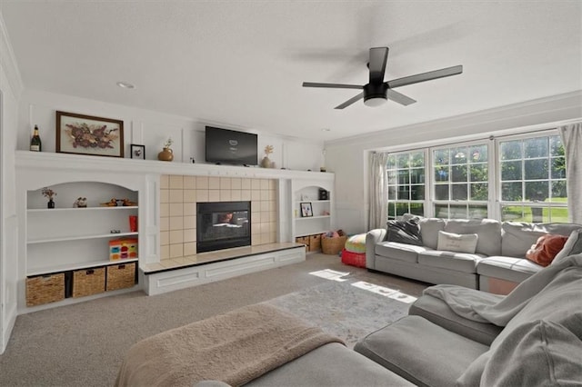8443 Mettee St, Lenexa, KS 66219 - carpeted living area featuring ceiling fan, built in shelves, and a tiled fireplace