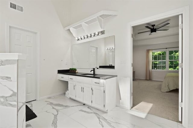 8443 Mettee St, Lenexa, KS 66219 - full bathroom featuring vanity, marble finish floors, baseboards, a ceiling fan, and ensuite bathroom