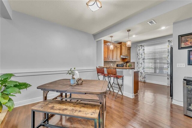 15828 W 61st St, Shawnee, KS 66217 - dining space with wood finished floors, baseboards, and wine cooler