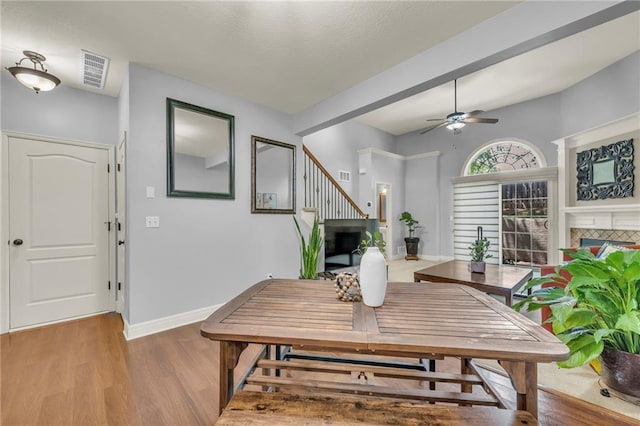 15828 W 61st St, Shawnee, KS 66217 - dining area featuring a tiled fireplace, wood finished floors, ceiling fan, and baseboards
