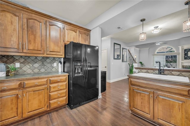 15828 W 61st St, Shawnee, KS 66217 - kitchen with black fridge, brown cabinets, dark wood-type flooring, backsplash, and a ceiling fan