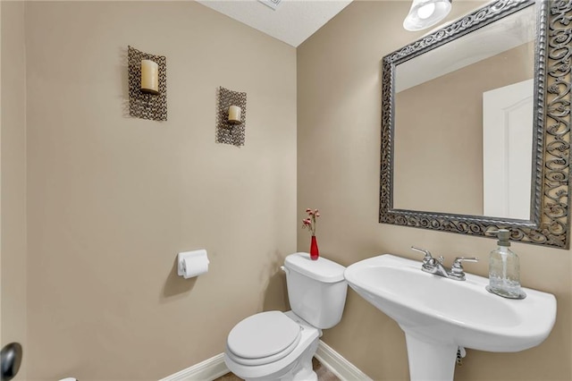 15828 W 61st St, Shawnee, KS 66217 - half bath with toilet, baseboards, and a sink
