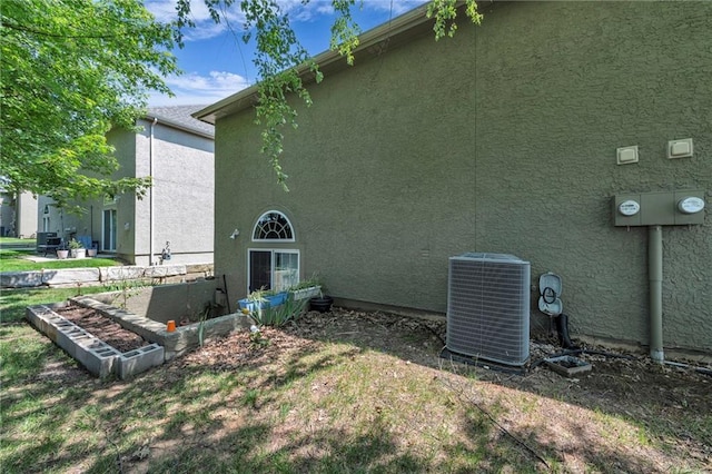 15828 W 61st St, Shawnee, KS 66217 - view of side of property featuring central AC unit and stucco siding
