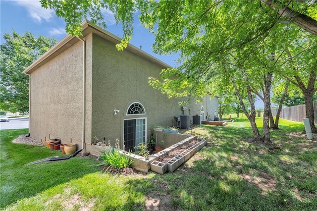15828 W 61st St, Shawnee, KS 66217 - back of property with stucco siding and cooling unit