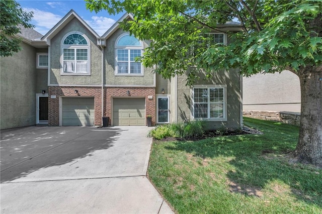 15828 W 61st St, Shawnee, KS 66217 - view of property featuring driveway, stucco siding, an attached garage, and a front yard