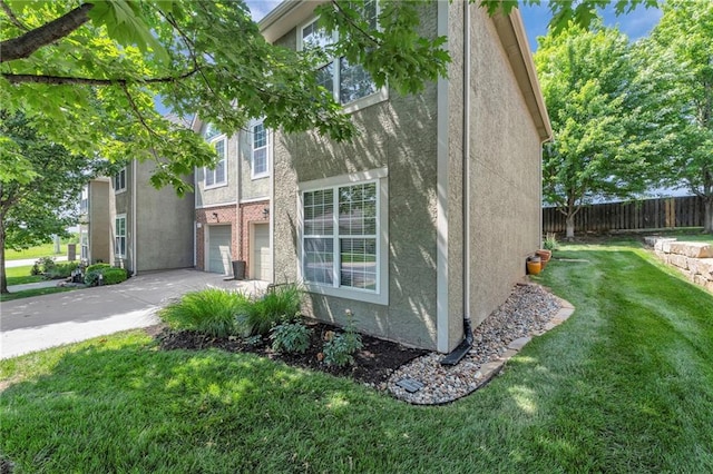 15828 W 61st St, Shawnee, KS 66217 - view of property exterior featuring stucco siding, driveway, and an attached garage