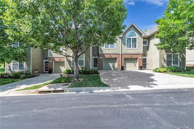 15828 W 61st St, Shawnee, KS 66217 - view of front facade featuring an attached garage, driveway, and stucco siding