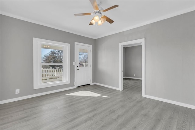 311 N Silver St, Paola, KS 66071 - spare room with ceiling fan, wood finished floors, and baseboards