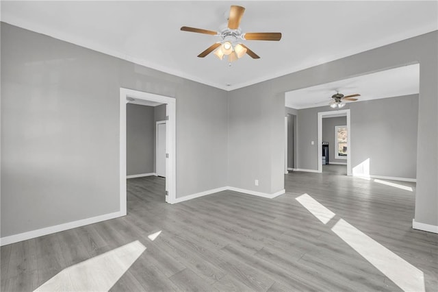 311 N Silver St, Paola, KS 66071 - spare room featuring a ceiling fan, baseboards, and wood finished floors