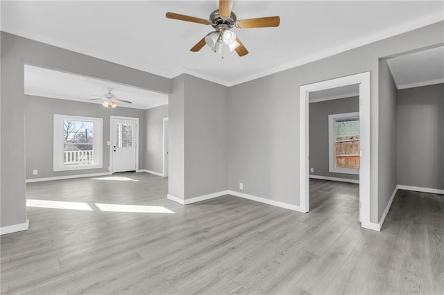 311 N Silver St, Paola, KS 66071 - unfurnished room featuring a ceiling fan, baseboards, ornamental molding, and wood finished floors