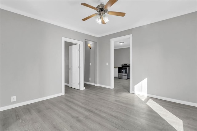 311 N Silver St, Paola, KS 66071 - unfurnished room with ceiling fan, baseboards, and wood finished floors