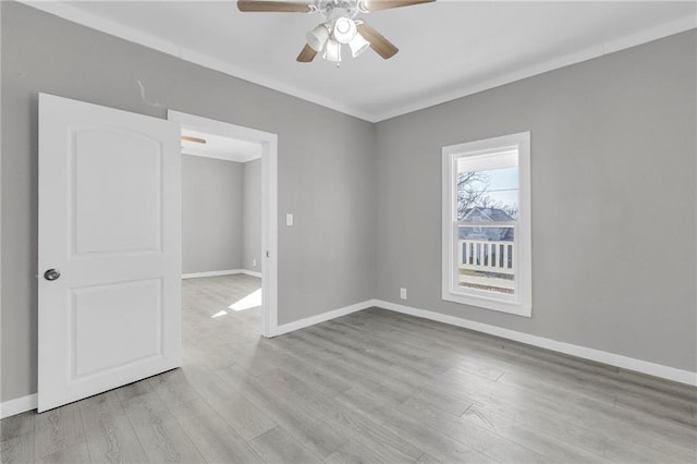 311 N Silver St, Paola, KS 66071 - unfurnished room with a ceiling fan, wood finished floors, baseboards, and crown molding