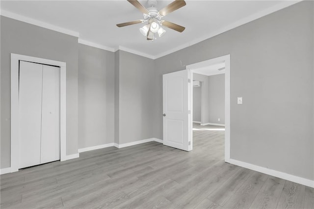311 N Silver St, Paola, KS 66071 - unfurnished bedroom with light wood-style floors, baseboards, crown molding, a ceiling fan, and a closet