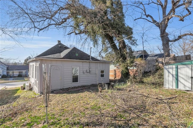311 N Silver St, Paola, KS 66071 - back of house featuring an outbuilding