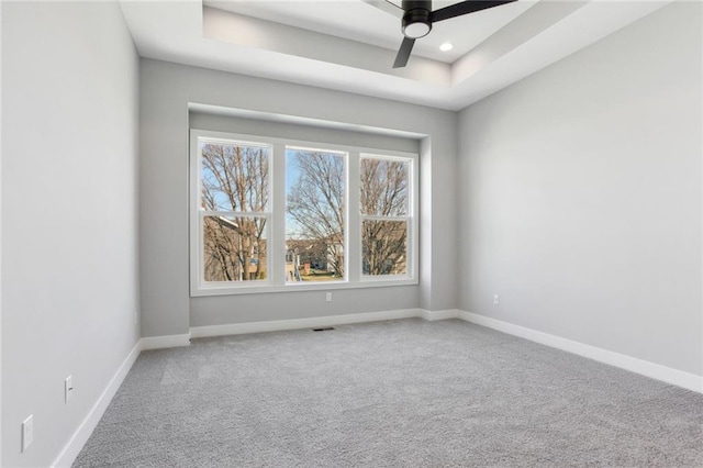 12425 NW Empress St, Platte City, MO 64079 - carpeted empty room featuring ceiling fan, baseboards, a raised ceiling, and recessed lighting