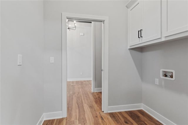 12425 NW Empress St, Platte City, MO 64079 - laundry area featuring cabinet space, hookup for a washing machine, wood finished floors, and baseboards