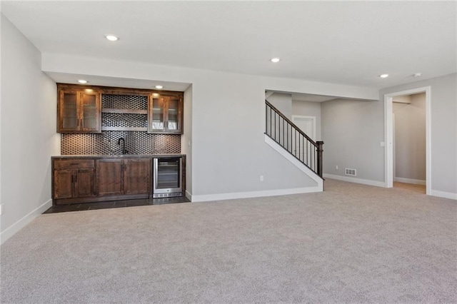 12425 NW Empress St, Platte City, MO 64079 - indoor wet bar with stairs, recessed lighting, beverage cooler, carpet floors, and decorative backsplash
