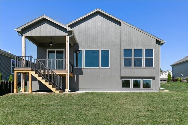 12425 NW Empress St, Platte City, MO 64079 - back of house featuring ceiling fan, stairs, and a lawn