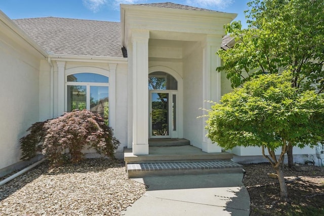 165 NE Hidden Ridge Ln, Lees Summit, MO 64064 - doorway to property featuring roof with shingles and stucco siding