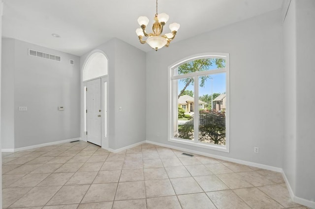 165 NE Hidden Ridge Ln, Lees Summit, MO 64064 - empty room with a chandelier, light tile patterned floors, and baseboards