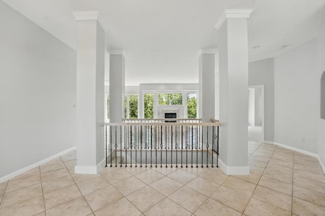 165 NE Hidden Ridge Ln, Lees Summit, MO 64064 - tiled spare room featuring decorative columns, baseboards, and crown molding