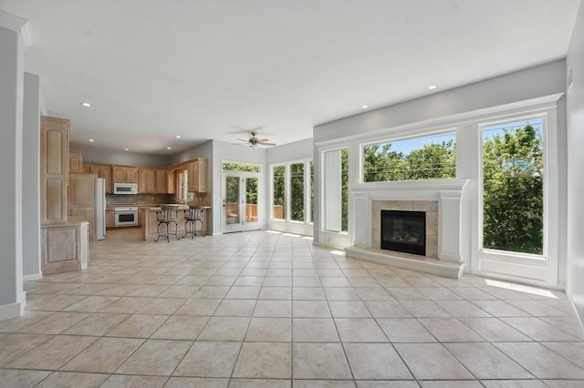 165 NE Hidden Ridge Ln, Lees Summit, MO 64064 - unfurnished living room with ceiling fan, light tile patterned floors, a fireplace, baseboards, and recessed lighting