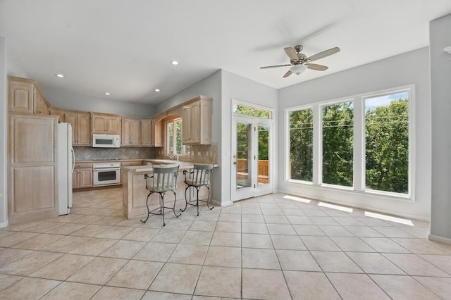 165 NE Hidden Ridge Ln, Lees Summit, MO 64064 - kitchen featuring white appliances, light brown cabinets, tasteful backsplash, ceiling fan, and recessed lighting