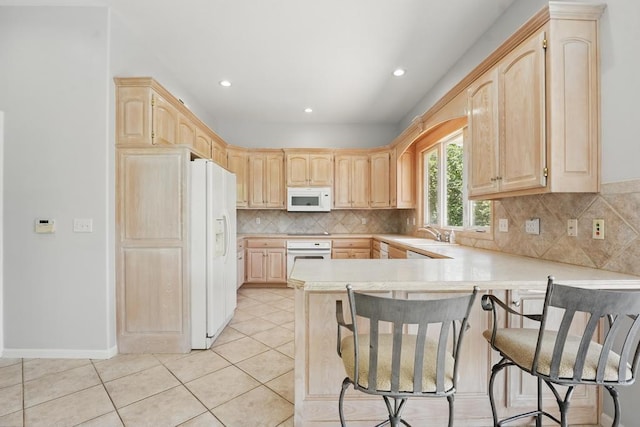 165 NE Hidden Ridge Ln, Lees Summit, MO 64064 - kitchen with white appliances, light brown cabinetry, a peninsula, light countertops, and recessed lighting