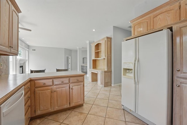 165 NE Hidden Ridge Ln, Lees Summit, MO 64064 - kitchen with white appliances, a peninsula, light tile patterned floors, light brown cabinets, and a fireplace