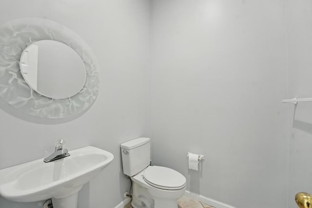 165 NE Hidden Ridge Ln, Lees Summit, MO 64064 - bathroom featuring a sink, baseboards, toilet, and tile patterned floors
