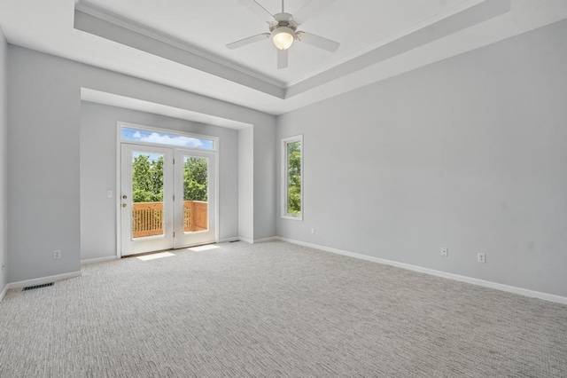 165 NE Hidden Ridge Ln, Lees Summit, MO 64064 - carpeted empty room featuring a raised ceiling, baseboards, and a ceiling fan