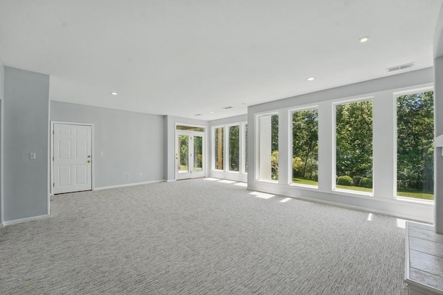 165 NE Hidden Ridge Ln, Lees Summit, MO 64064 - unfurnished living room with carpet flooring, baseboards, and recessed lighting