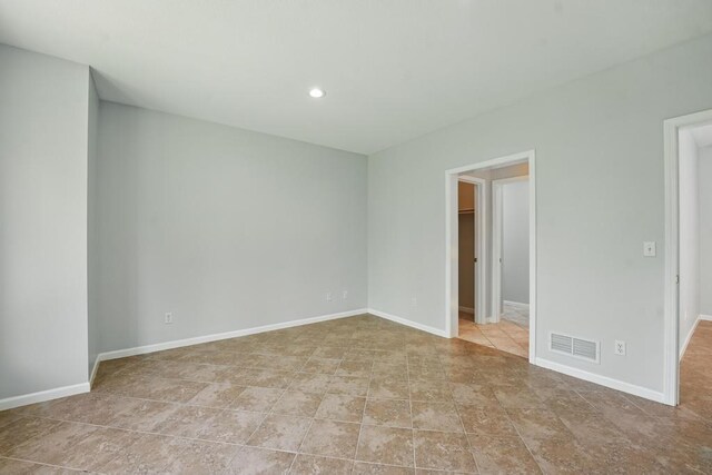 165 NE Hidden Ridge Ln, Lees Summit, MO 64064 - spare room featuring recessed lighting and baseboards