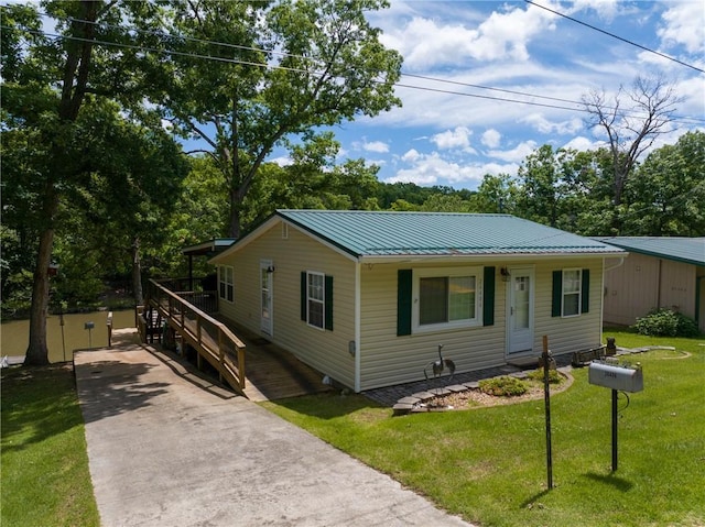 26406 Waterview Dr, Warsaw, MO 65355 - view of front facade with a front yard, covered porch, metal roof, and concrete driveway