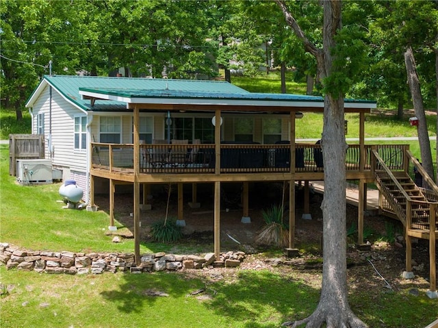 26406 Waterview Dr, Warsaw, MO 65355 - rear view of house with a wooden deck, a yard, and metal roof