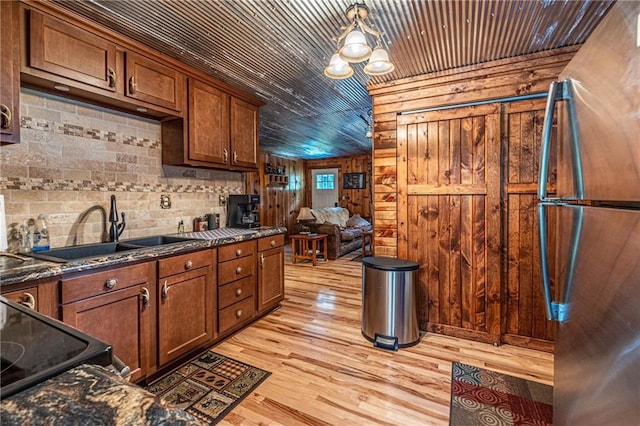 26406 Waterview Dr, Warsaw, MO 65355 - kitchen with freestanding refrigerator, a sink, wooden ceiling, wood walls, and light wood finished floors