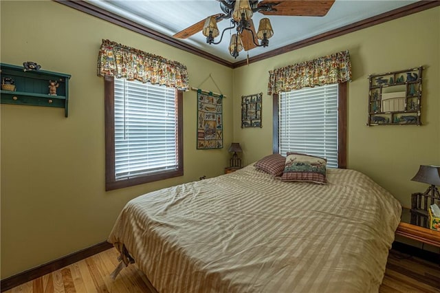 26406 Waterview Dr, Warsaw, MO 65355 - bedroom with wood finished floors, baseboards, crown molding, and a ceiling fan