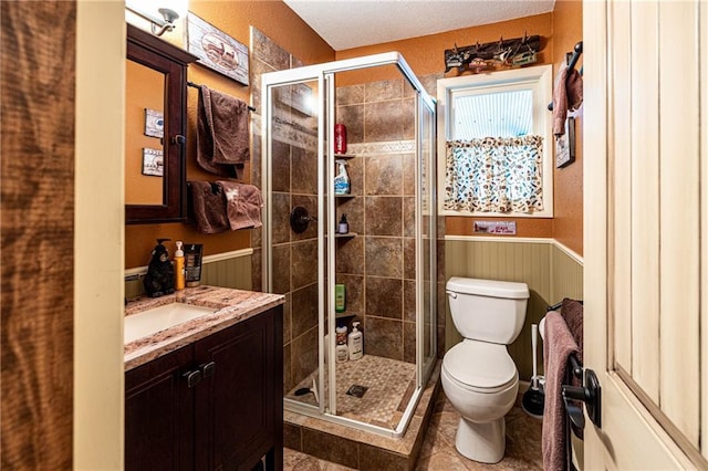 26406 Waterview Dr, Warsaw, MO 65355 - full bath featuring toilet, vanity, tile patterned floors, a shower stall, and a wainscoted wall