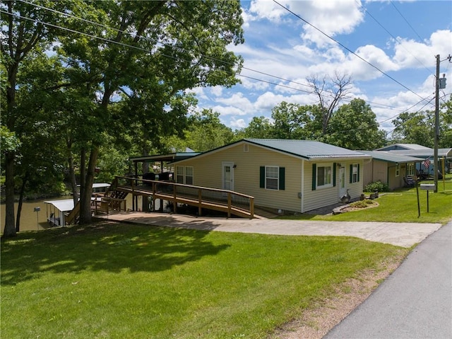 26406 Waterview Dr, Warsaw, MO 65355 - view of front of house with a deck, a front yard, and metal roof
