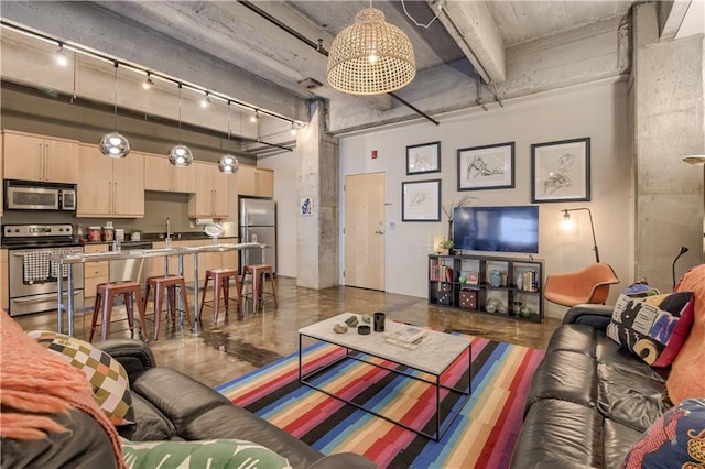 360 W Pershing Rd Unit 250, Kansas City, MO 64108 - living area with a high ceiling and rail lighting