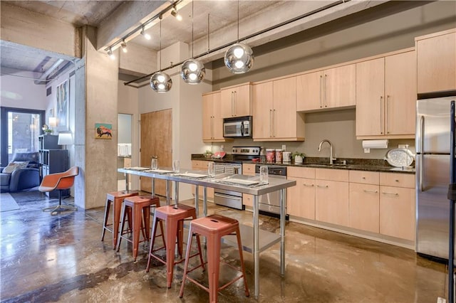 360 W Pershing Rd Unit 250, Kansas City, MO 64108 - kitchen with appliances with stainless steel finishes, a sink, concrete flooring, dark countertops, and a high ceiling