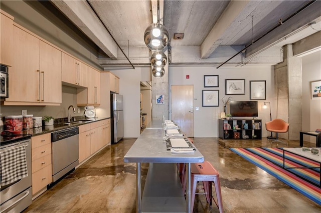 360 W Pershing Rd Unit 250, Kansas City, MO 64108 - kitchen with stainless steel appliances, light brown cabinets, a sink, and concrete floors