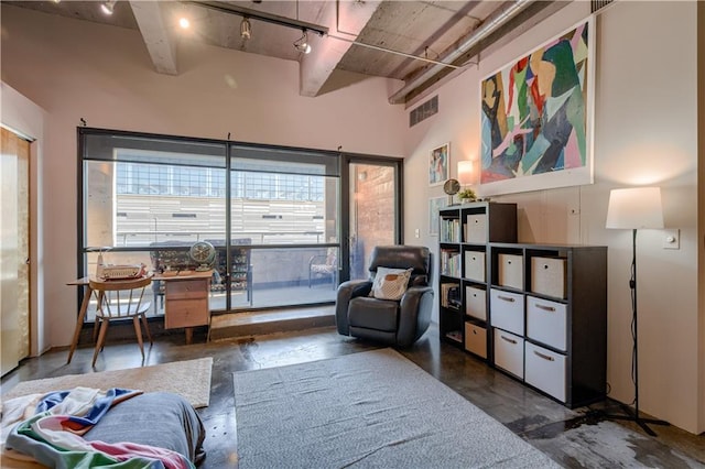 360 W Pershing Rd Unit 250, Kansas City, MO 64108 - living area with track lighting, plenty of natural light, concrete floors, and a high ceiling