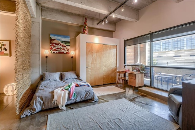 360 W Pershing Rd Unit 250, Kansas City, MO 64108 - bedroom featuring concrete floors, track lighting, and a closet
