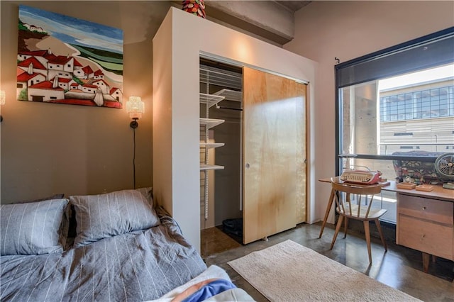 360 W Pershing Rd Unit 250, Kansas City, MO 64108 - bedroom featuring concrete flooring and a closet
